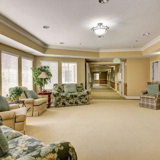 A cozy interior hallway with comfortable seating and large windows.