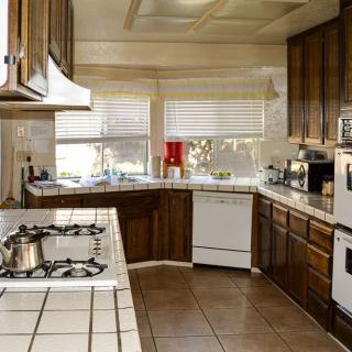 A spacious kitchen with wooden cabinets and modern appliances.