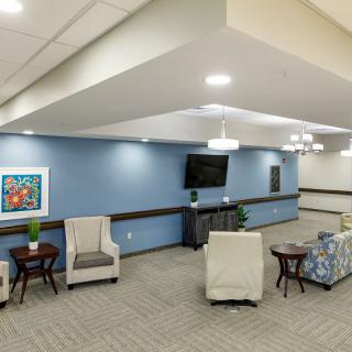 A modern lounge area featuring comfortable seating, a television, and stylish decor.