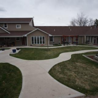 A residential house with a courtyard and winding pathways.