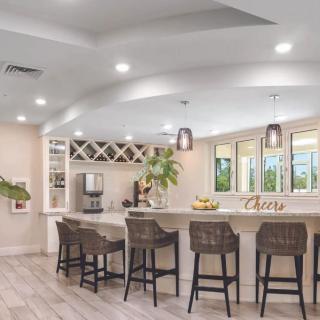 A modern kitchen with bar seating and stylish pendant lighting.
