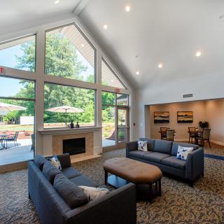 A modern living room with high ceilings, large windows, and contemporary furnishings.