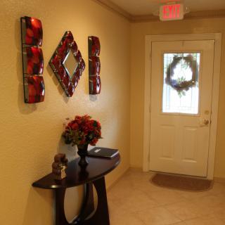 A warmly decorated entrance with holiday wreath and stylish wall art.