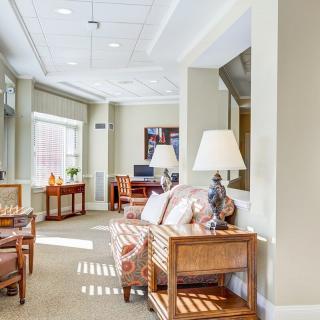 A well-lit living room with comfortable seating and elegant decor.