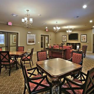 A cozy lounge area with stylish furniture and chandeliers, providing a welcoming atmosphere.