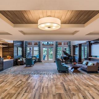 A spacious and modern lobby interior with a seating area and piano.