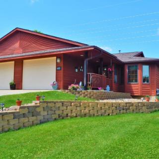 A suburban house with a well-maintained lawn and a two-car garage.