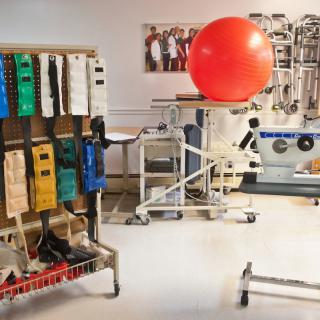 A physical therapy room equipped with various rehabilitation tools and exercise equipment.