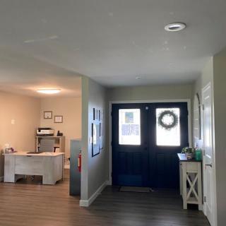 A cozy home entrance with a decorated door and adjacent workspace.