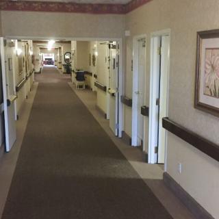 A well-lit interior hallway with multiple doors and decorative elements on the walls.
