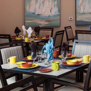 A well-arranged dining area with colorful table settings and elegant decor.