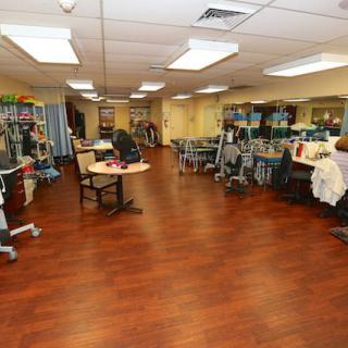 A rehabilitation center featuring a spacious therapy room equipped with various exercise machines.