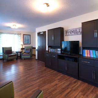A cozy and inviting living room with modern furniture, a television, and a warm ambiance.