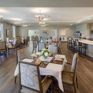 A modern dining area with elegantly set tables and comfortable seating.
