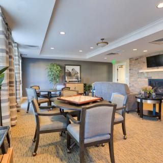 A cozy living room with comfortable seating, a television, and a decorative table setup.
