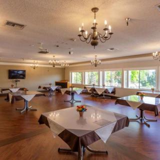 A spacious dining area with elegantly set tables and natural lighting.