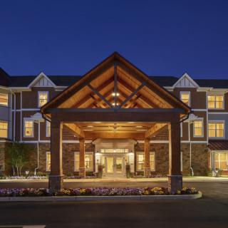 A well-lit hotel entrance at night showcasing elegant architecture.