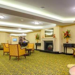 A spacious lobby area with comfortable seating and a decorative fireplace.
