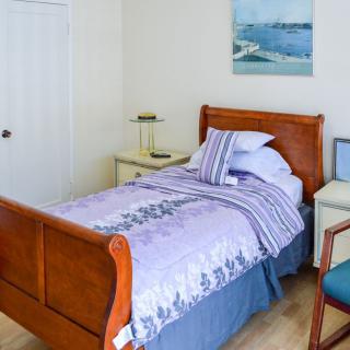 A cozy bedroom with a single bed and wooden furniture.
