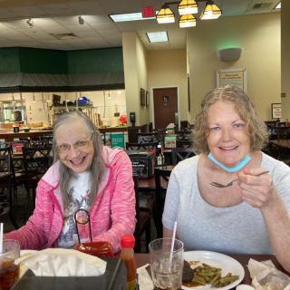Two people enjoy a meal together at a restaurant.