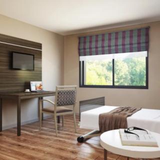 A modern and minimalist bedroom interior with a desk, chair, and bed near a window.