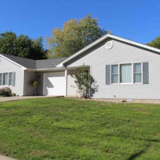 A single-story suburban house with a well-maintained lawn.