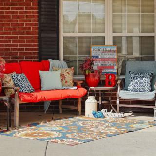 A cozy outdoor patio setup with colorful cushions and decor.