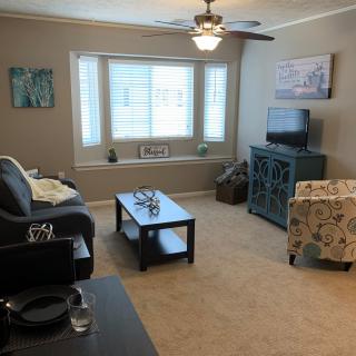 A cozy living room with comfortable seating and natural light.