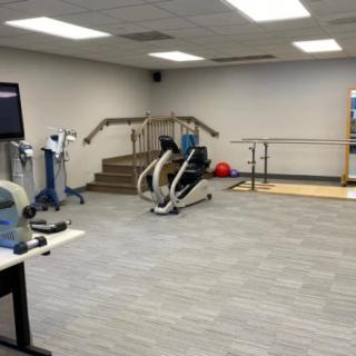 A fitness facility featuring various exercise machines and rehabilitation equipment.