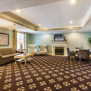 A neatly arranged living room with elegant furniture and a cozy fireplace.