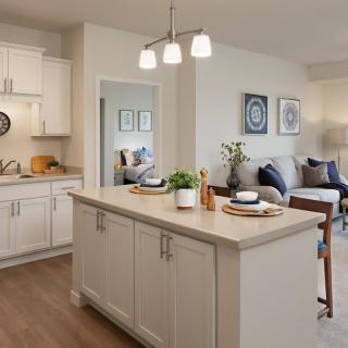 A modern open-concept kitchen and living area featuring a central island with seating.