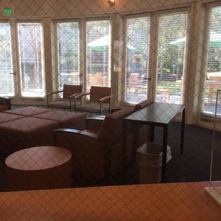 A cozy lounge area with ample natural light and comfortable seating.