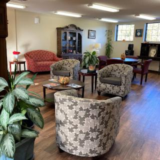 A cozy lounge area featuring comfortable seating and decorative plants.