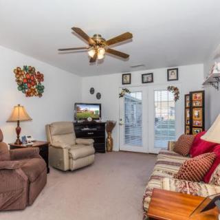 A cozy living room with comfortable seating, a TV, and decorative elements.