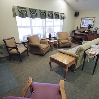A cozy living room with comfortable seating and a large window.
