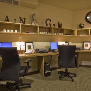 A modern office space with multiple workstations and computers.