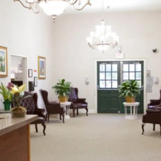 A well-furnished lobby area with seating and a chandelier.