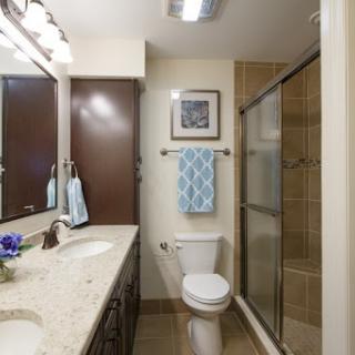 A modern bathroom featuring a stylish vanity, shower, and decorative elements.
