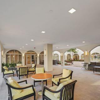 A spacious patio with comfortable seating and arches.