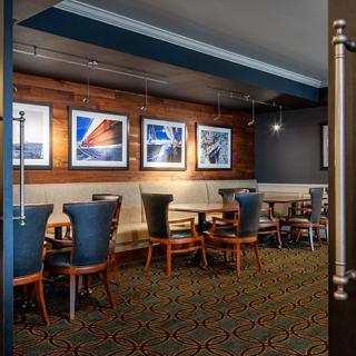 A modern restaurant dining area with stylish seating and art-adorned walls.