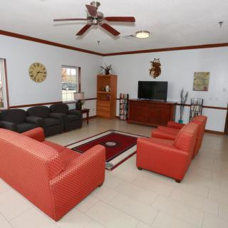 A spacious living room with modern furniture and decor.