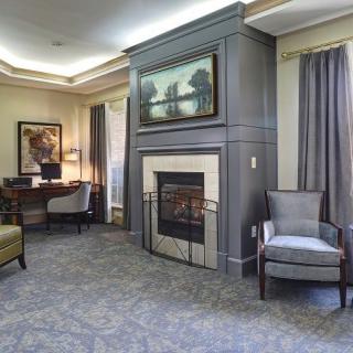 A cozy living room featuring a modern fireplace and comfortable seating.