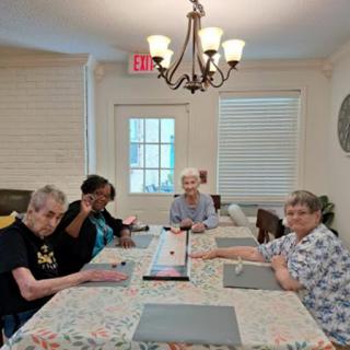 A group of senior citizens engaged in an activity together at a community center.