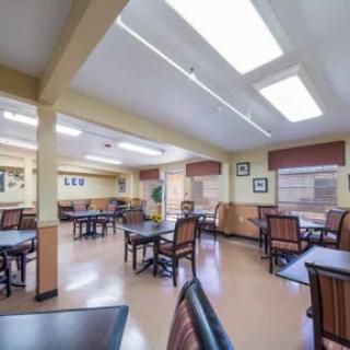 A spacious dining area with tables and chairs, designed for social gatherings.
