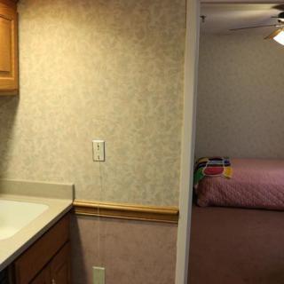 View of a kitchen area leading into a bedroom.