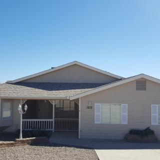 A suburban residential house with a driveway and front porch.