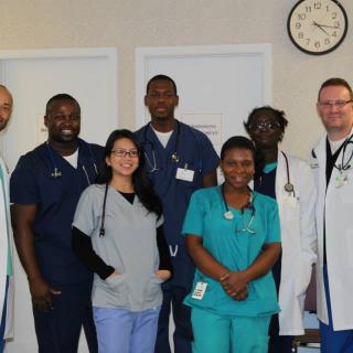 A group of medical professionals posing together in a hospital setting.