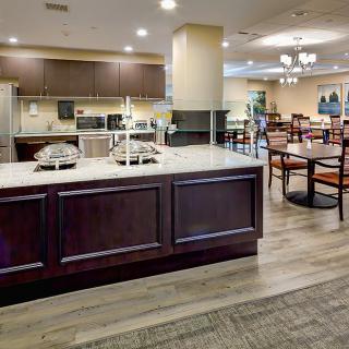 A modern kitchen and dining area with wooden flooring and stylish furnishings.