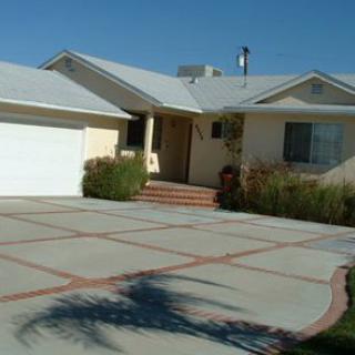 A suburban house with a large driveway and garage.