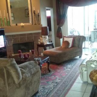 A cozy living room with a fireplace, sofas, and elegant decor.